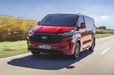 Rode Ford Transit vooraanzicht op weg